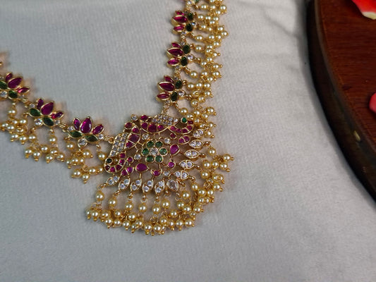 Peacock Guttapusalu Necklace Set — Antique Gold Ruby & Emerald Lotus Chain with Pearl Drops & Stud Earrings